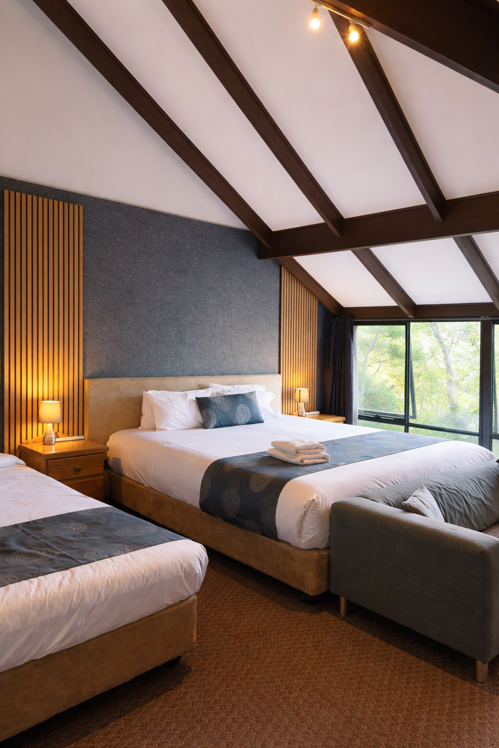 King suite with timber feature wall and garden views