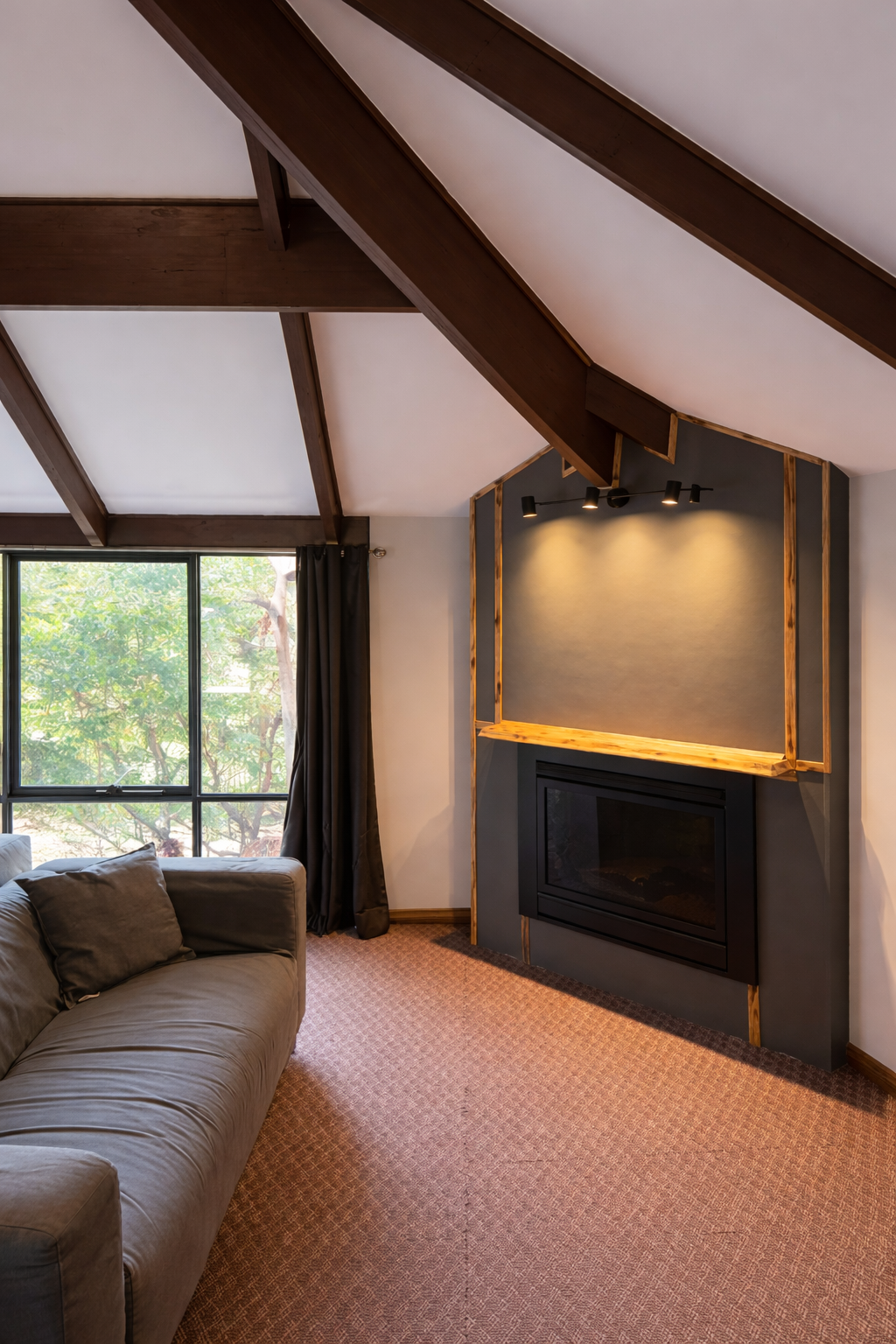 Lounge area with exposed timber beams and gas fireplace