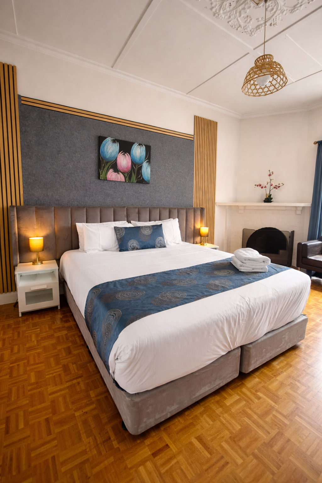 Deluxe king room with upholstered bed and ornate ceiling
